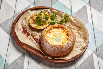 Cheese soup served in round bread loaf