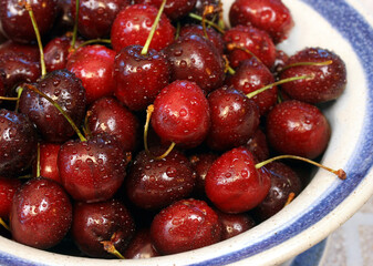 Fresh washed red sweet cherries in a bowl, macro.