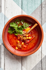 Tomato soup with mutton and chickpea top view