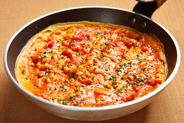 Omelette with tomatoes and seasoning