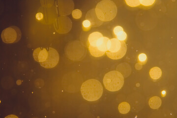 Dark Abstract Gold bokeh sparkle on black background