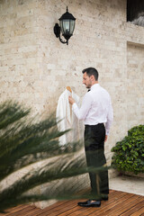 Latino groom checking out his with tuxedo