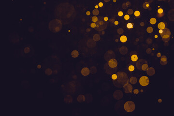 Fantasy gold bokeh sparkle from light on black