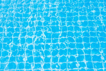 Reflections from the water in the blue swimming pool