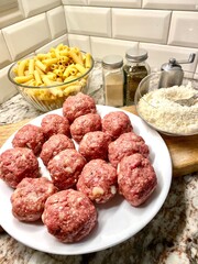 Meatballs, cheese, pasta and spices for cooking an Italian meal.