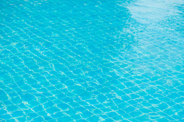Reflections from the water in the blue swimming pool