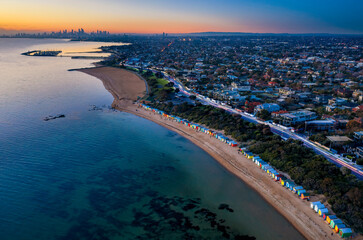 Aerial sunset view of Brighton beach, with St Kilda Marina and the city of Melbourne in the...