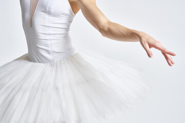Fototapeta premium Ballerina in white tutu elegant dance performed sensuality silhouette light background