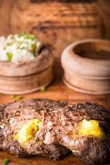 Beef steak served with mashed potato and gravy with melting butter