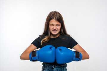  Young girl with braces in blue boxing gloves, isolated