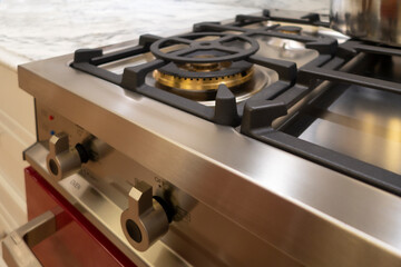 stainless steel range / oven ketchen appliance burners and buttons with marble counter top