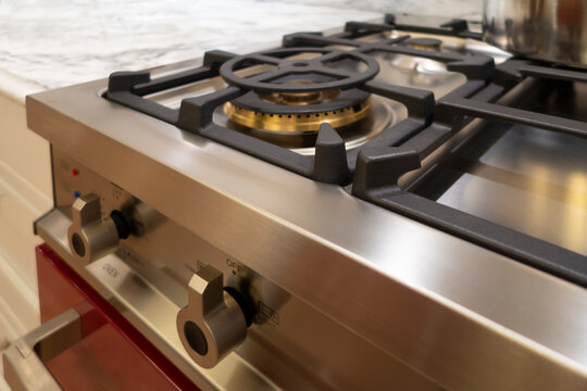 stainless steel range / oven ketchen appliance burners and buttons with marble counter top