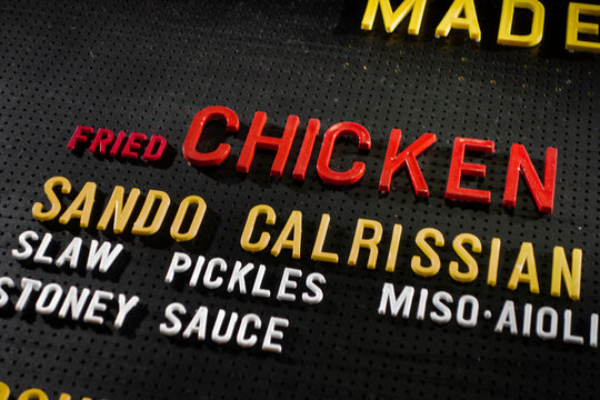 Overhead black meau board with plastic colorful letters