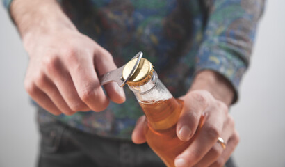 Man opening a bottle of beer.