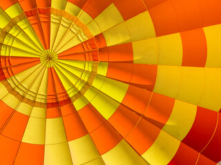 Bright yellow and orange fragment of hot air balloon shot from below