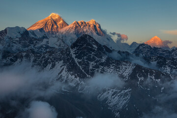 Fototapeta na wymiar Mounts Everest, Lhotse and Makalu at sunset with tops lightened by the last golden sunlight