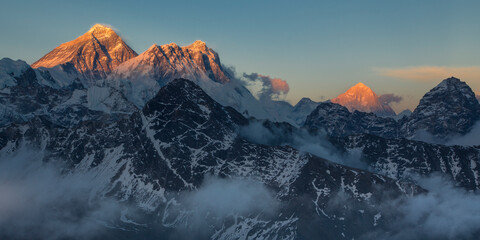 Mounts Everest, Lhotse and Makalu at sunset with tops lightened by the last golden sunlight