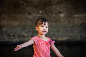 little girl portrait on the river 
drinking water from the river 