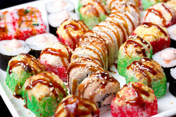 set of different types of sushi on a white plate