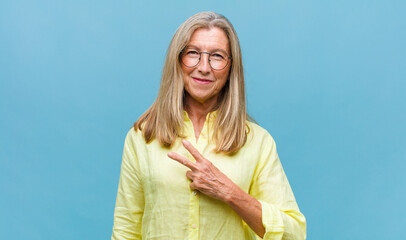 middle age pretty woman feeling extremely shocked and surprised, anxious and panicking, with a...