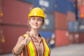 Cheerful female engineer smiling and looking the sky with giving thumbs up as sign of success