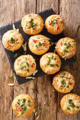 Corn muffins with crab meat and cheese close-up on a slate board on the table. Vertical top view from above