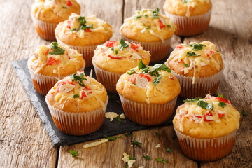 Homemade spicy corn muffins with crab herbs and cheese close-up on a slate board on the table. horizontal