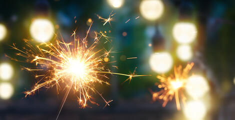 Happy New Year, Burning sparkler with bokeh light background