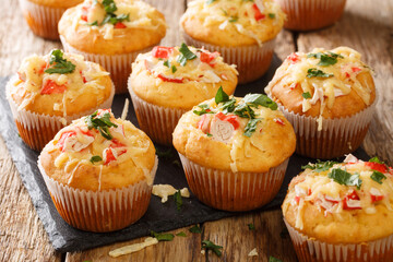 American snack corn muffins stuffed with crab herbs and cheese close-up on a slate board on the table. horizontal