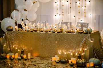 Table setting for wedding. Decorated arch for wedding ceremony. White balloons, candles, autumn...