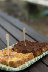 Slices of bread with milk and chocolate powder