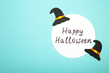 Happy halloween background with witch hat on blue.