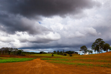 Dark storm clouds above rural landscape n the Atherton Tablelands in Tropical North Queensland, Australia