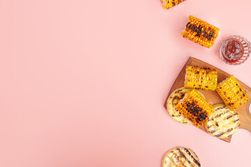 grilled vegetables corn on a pastel pink background, copies of space, flatlay