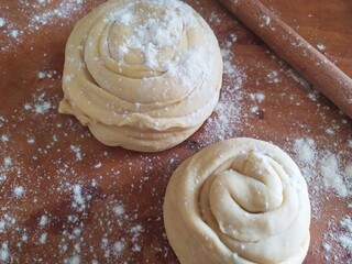 Two pieces of dough on a wooden board