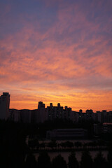Fototapeta na wymiar Autumn sky sunset and clouds, the building