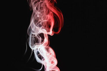 Red smoke on a black background. Colored smoke. Incense stick smoke, illuminated by red light.
