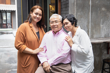 Fototapeta premium Asian family portrait of middle aged daughter with senior father and mother