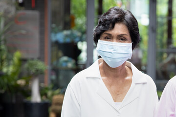 senior woman wearing facemask, face covering for sickness prevention