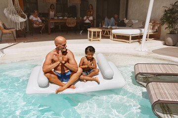 Pool. Father With Son Meditating And Floating On Inflatable Water Mattress. Dad And Kid Enjoying Vacation At Tropical Resort. Family Weekend In Villa. Happiness As Lifestyle.