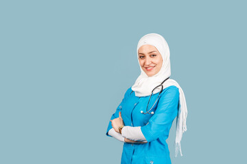 Portrait of a friendly, muslim doctor or nurse woman in hijab with a stethoscope on a blue...