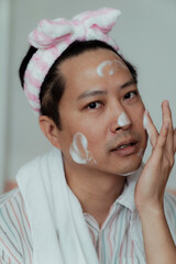 Asian gay wash his face in bathroom.