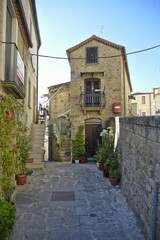 A small road crosses the old buildings of Pietrapertosa, a rural village in the Basilicata region, Italy.