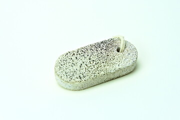 Pumice scrub stone for bathing and skincare, isolated on white.
