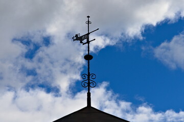 Dragon wind vane made from cast iron. Looks weathered and rusted.