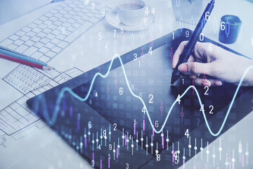 Double exposure of financial graph sketch hologram and woman holding and using a mobile device. Stock exchange concept.