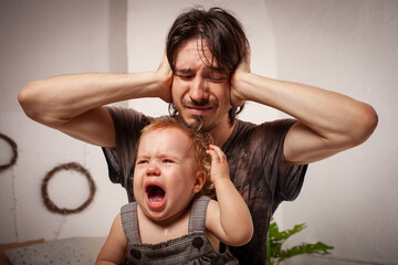 The child is screaming, hysterical. A tired dad doesn't want to hear the baby. The parent is...