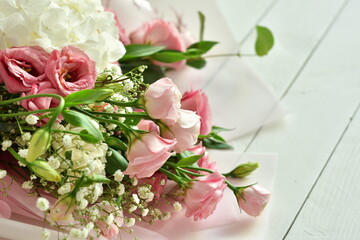 bouquet of delicate roses, eustoma, hydrangea on light background.Flowers composition.Mother's Day, Valentine's Day,birthday. Copy space. I love you concept.Wedding invitation.