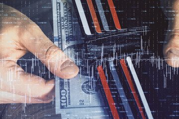 Multi exposure of forex graph drawing hologram and USA dollars bills and man hands. Technical...