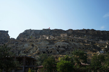 Fototapeta premium Natural landscape of Cappadocia, semi-arid region in central Turkey known for its distinctive fairy chimneys, tall cone-shaped rock formations clustered in Monks Valley, Göreme and elsewhere- Kayseri
